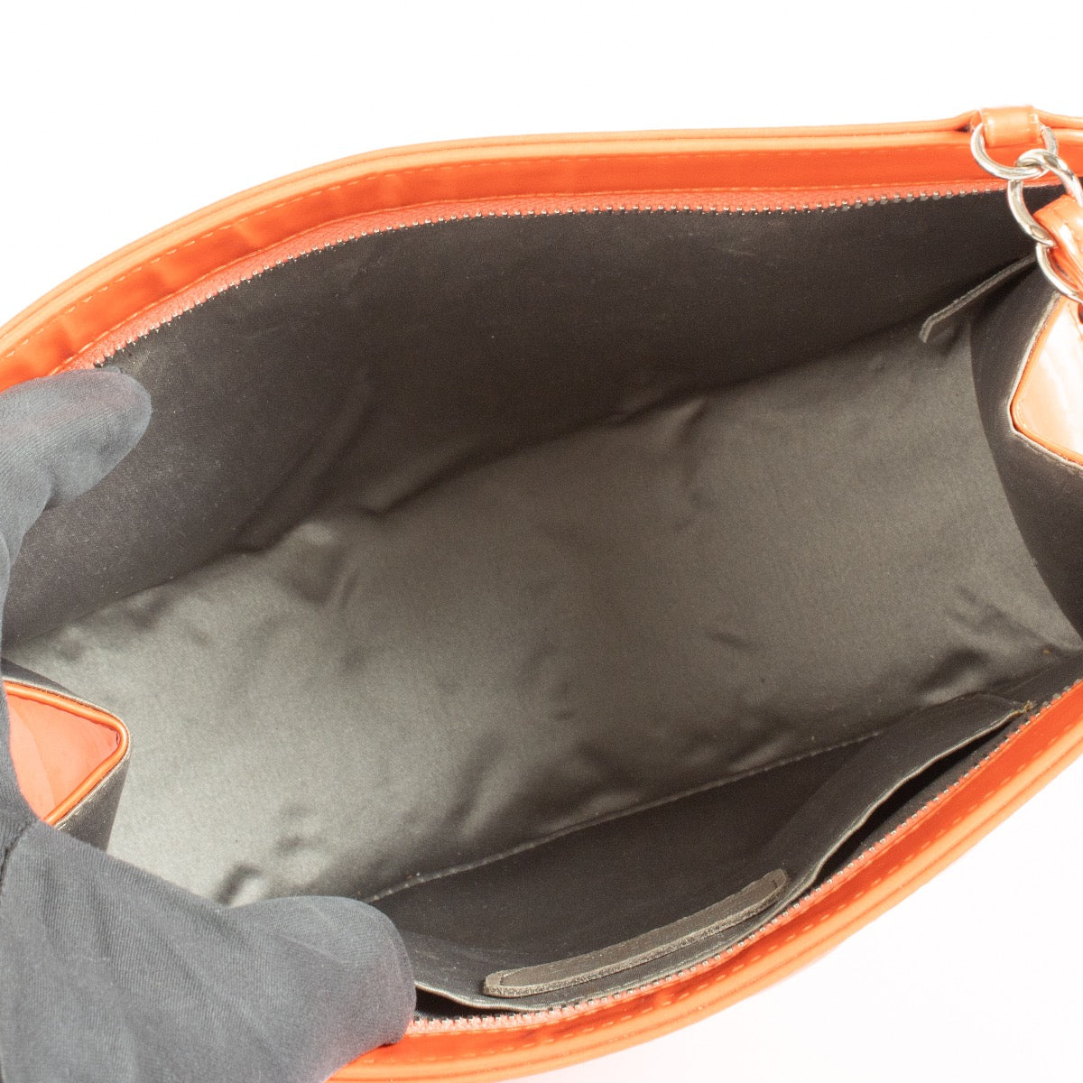 Authentic pre-loved Chanel Orange Patent Precious Symbols Bag on Labellov.com