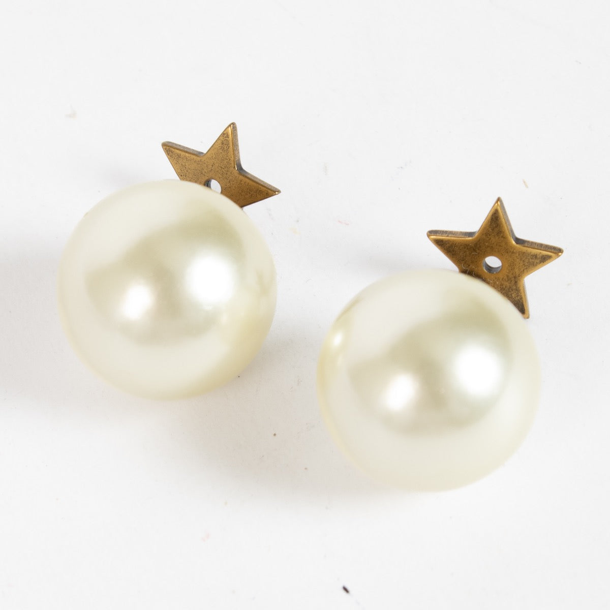 Dior gold-tone star and pearl earrings with Dior logo engraving at Labellov.com.