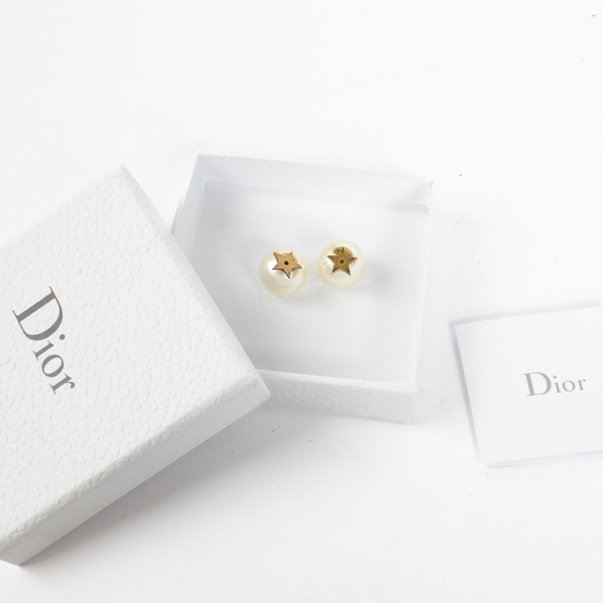 Dior gold-tone star and pearl earrings with Dior logo engraving at Labellov.com.