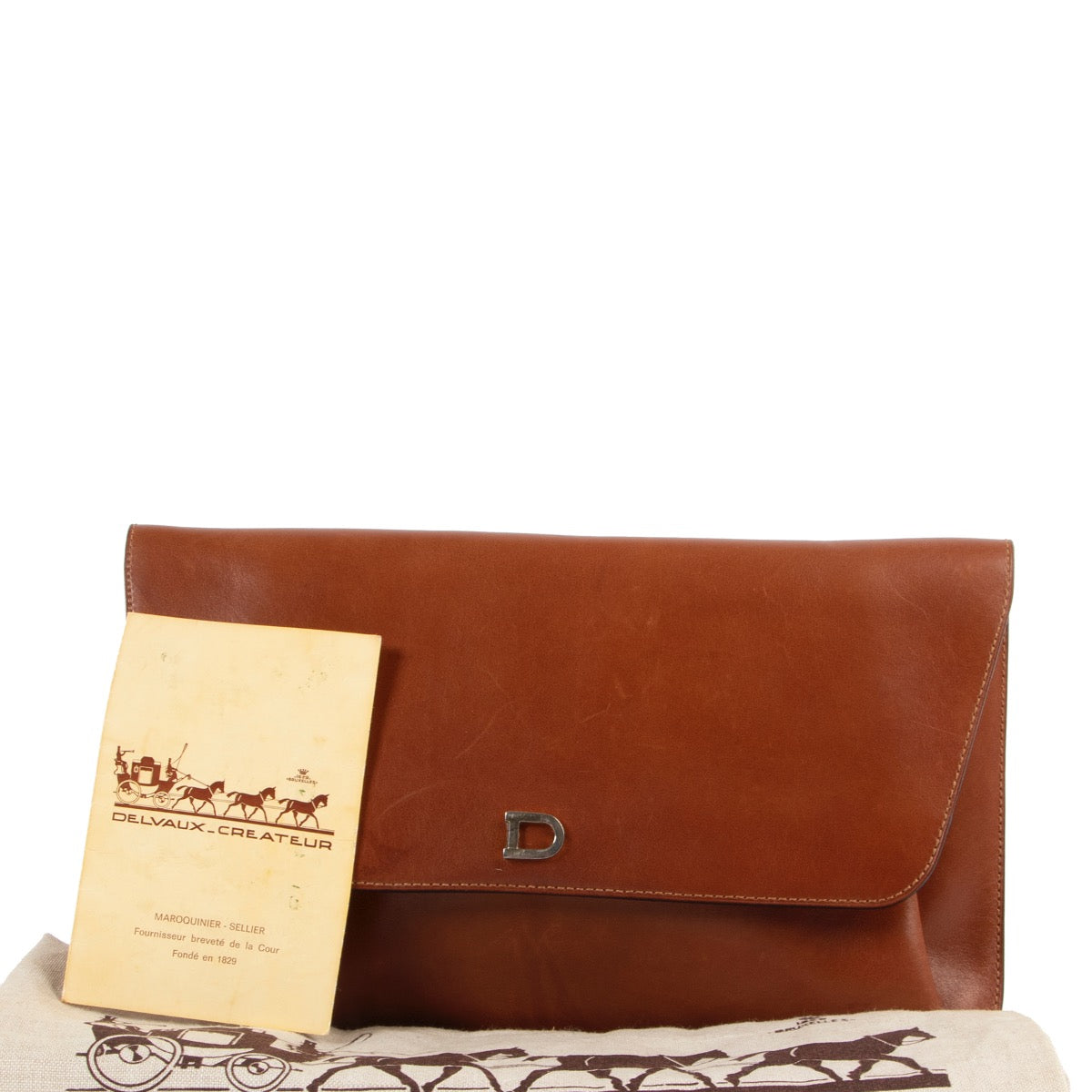 Buy an authentic second hand cognac Delvaux Clutch at Labellov