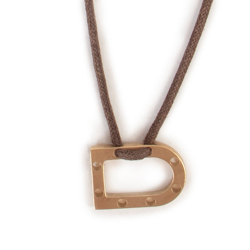 Shop authentic second hand vintage luxury designer fashion Delvaux Pale Gold D Pendant Necklace at Labellov