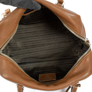 Prada Brown Vitello Daino Bauletto Bag crafted from textured Vitello Daino leather, featuring a sleek structured design, gold-tone hardware, and spacious interior.Shop now on Labellov.com.