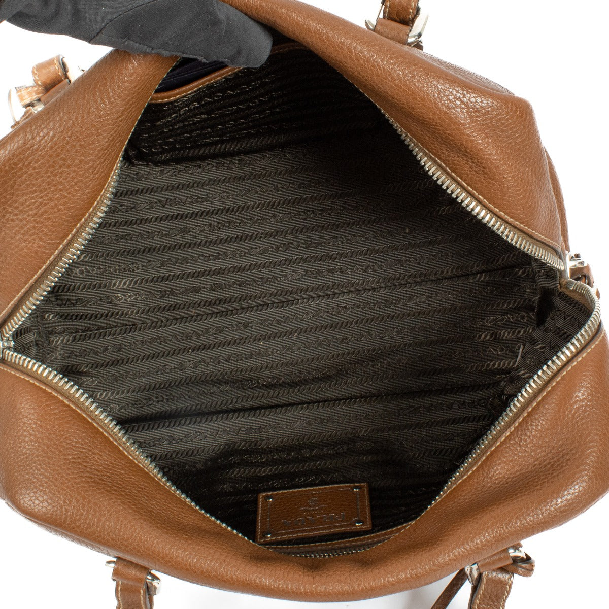 Prada Brown Vitello Daino Bauletto Bag crafted from textured Vitello Daino leather, featuring a sleek structured design, gold-tone hardware, and spacious interior.Shop now on Labellov.com.