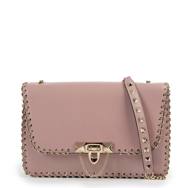 Buy online an authentic second hand Valentino Garavani Pink Rockstud Demilune Whipstitch Crossbody in good condition at Labellov in Antwerp.