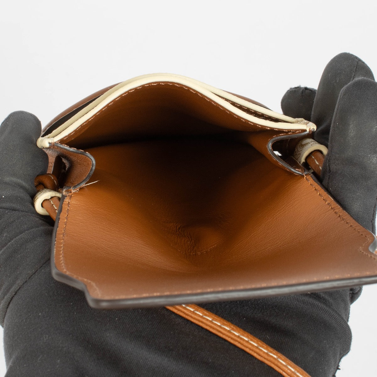 Authentic pre-loved Celine Brown/White Leather/Canvas Triomphe Phone holder on Labellov.com