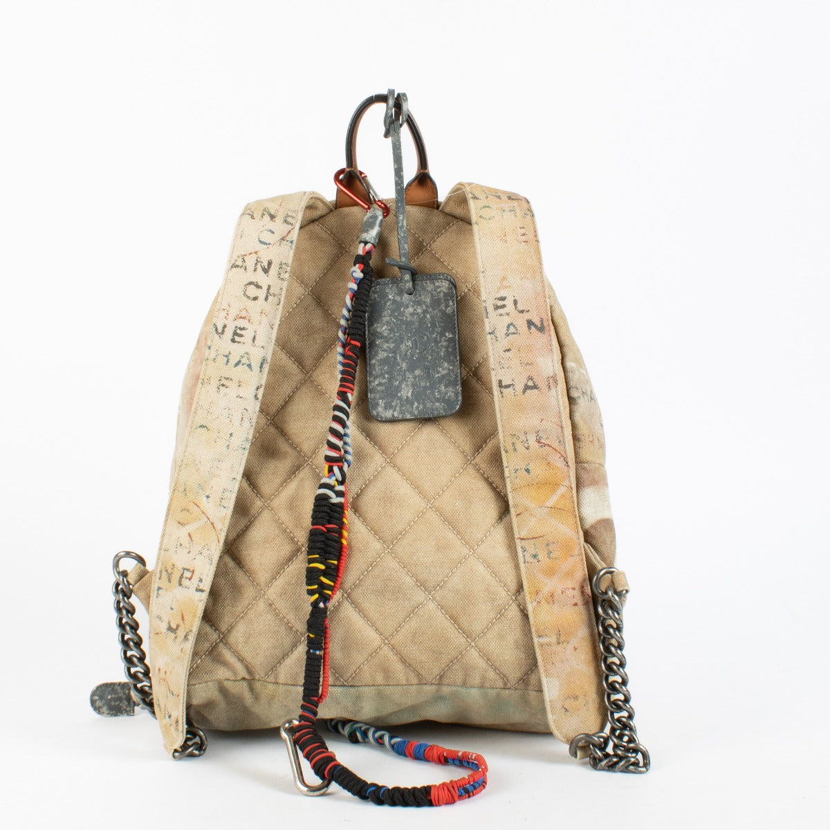 Chanel Beige Graffiti Backpack from 2014 with distressed canvas and rope accents at Labellov.com