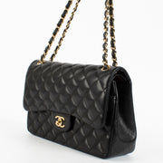 Chanel Black Jumbo Classic Flap Bag in lambskin with gold hardware at Labellov.com