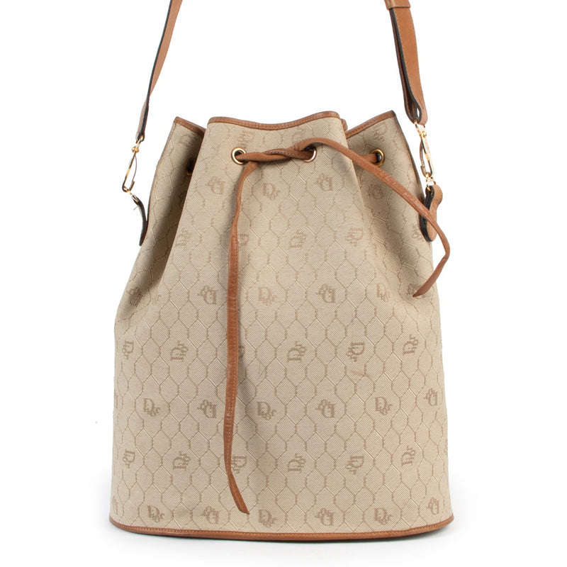 Shop now for your pre-loved, 100% authentic Christian Dior Beige Drawstring Toile Oblique Bucket Bag, at Labellov.