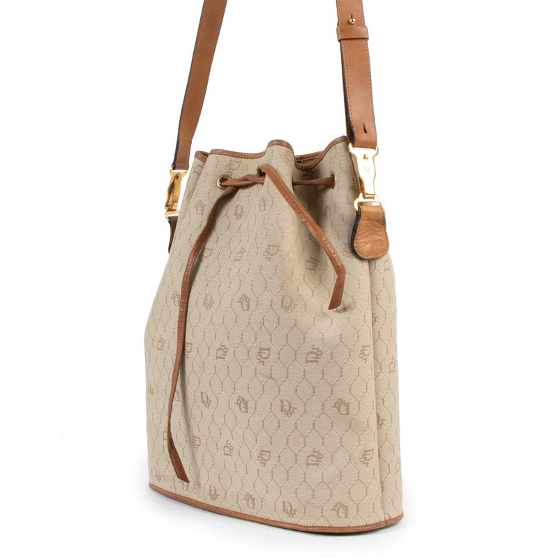 Shop now for your pre-loved, 100% authentic Christian Dior Beige Drawstring Toile Oblique Bucket Bag, at Labellov.