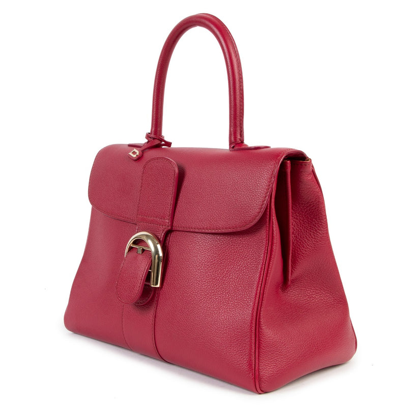 Buy online an authentic second hand Delvaux Brillant MM framboise Rodéo calf handbag in very good condition at Labellov in Antwerp.