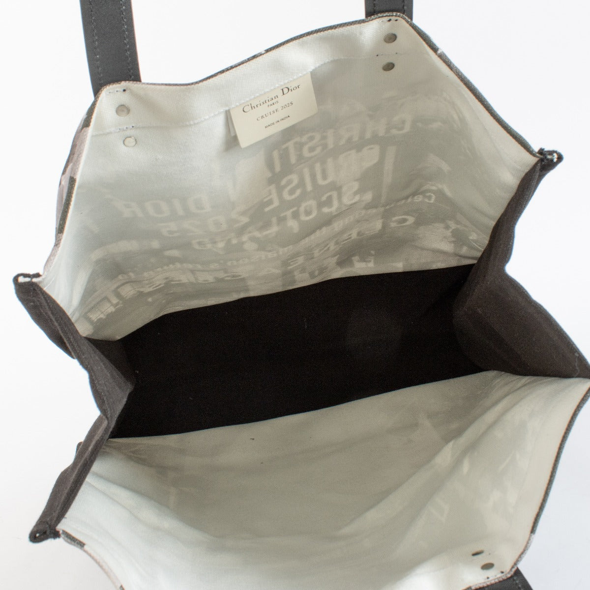 Christian Dior Cruise 2025 printed canvas tote bag with black leather handles at Labellov.com