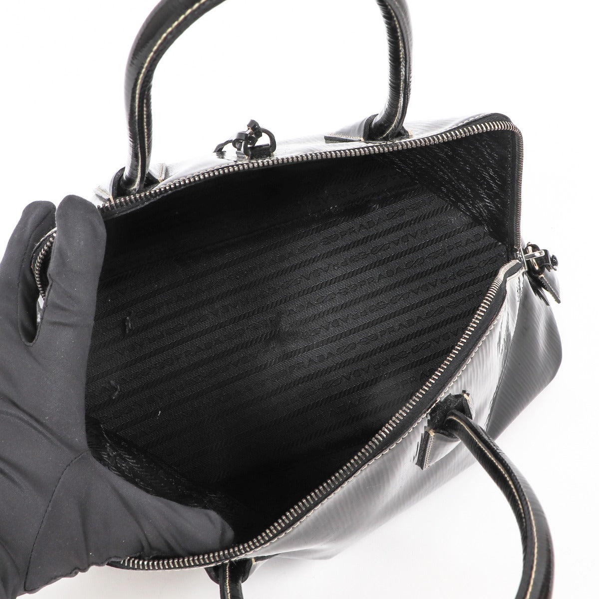 Buy an authentic second-hand Prada Black Patent Leather Spazzolato Logo Top Handle Bag in very good condition at Labellov in Antwerp.