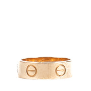 Authentic Cartier Love Ring in 18K rose gold, showing gentle wear and light scratches, complete with original box and certificate at Labellov.com.
