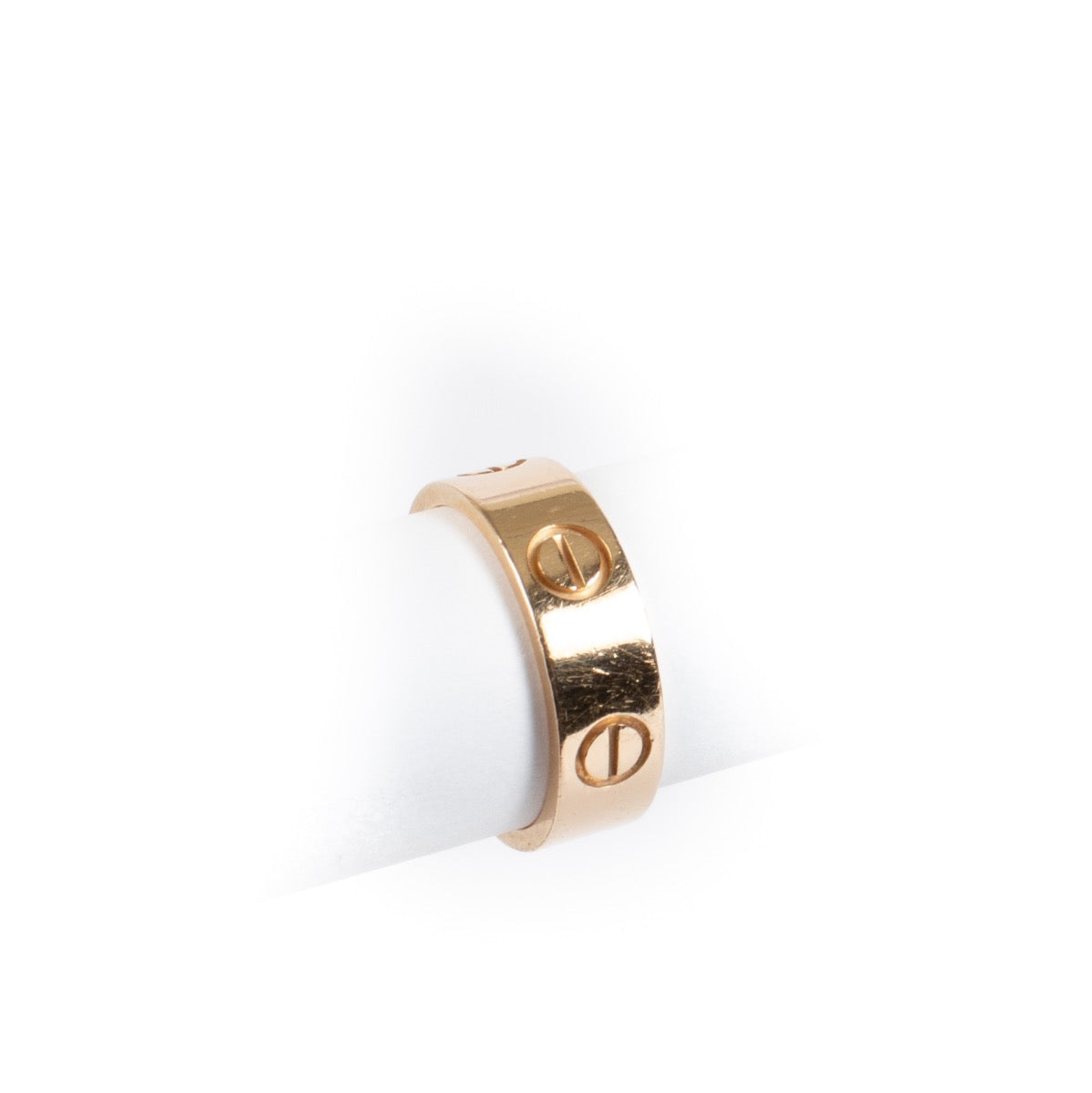 Authentic Cartier Love Ring in 18K rose gold, showing gentle wear and light scratches, complete with original box and certificate at Labellov.com.