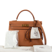 Are you looking to buy an authentic Hermès Kelly 32 Gold Courchevel GHW? We buy and sell your authentic designer bags for the best price.