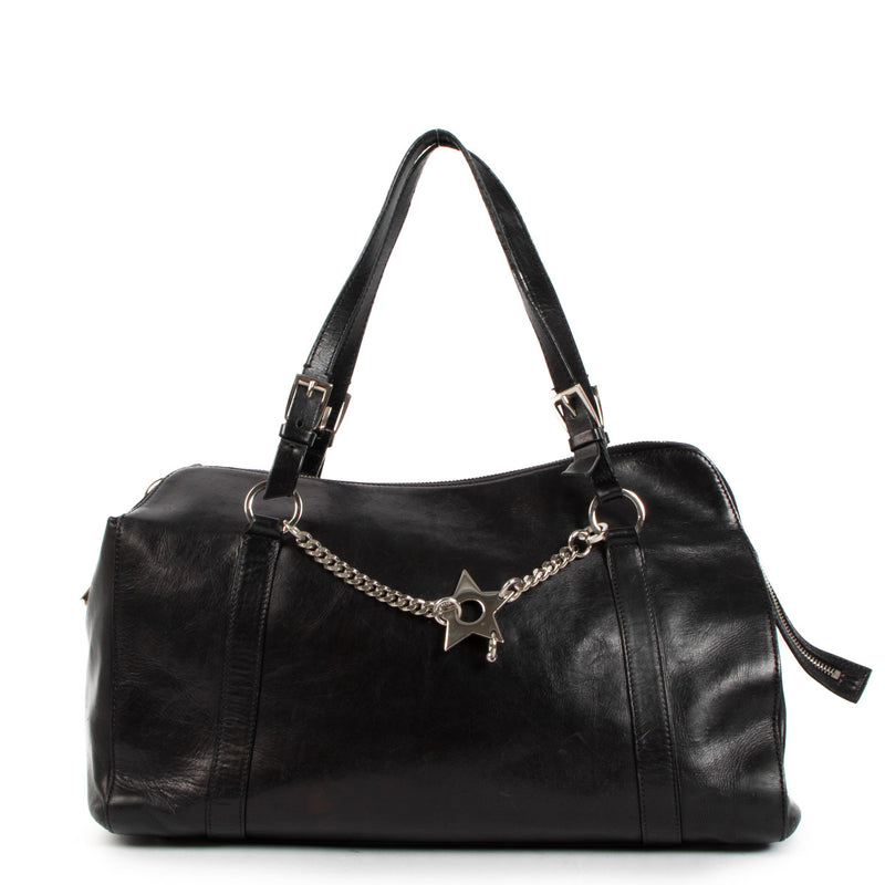 Christian Dior Black Hardcore Star Piercing Tote Bag for the best price at Labellov secondhand luxury in Antwerp. We buy and sell your preloved and new designer bags for the best price.