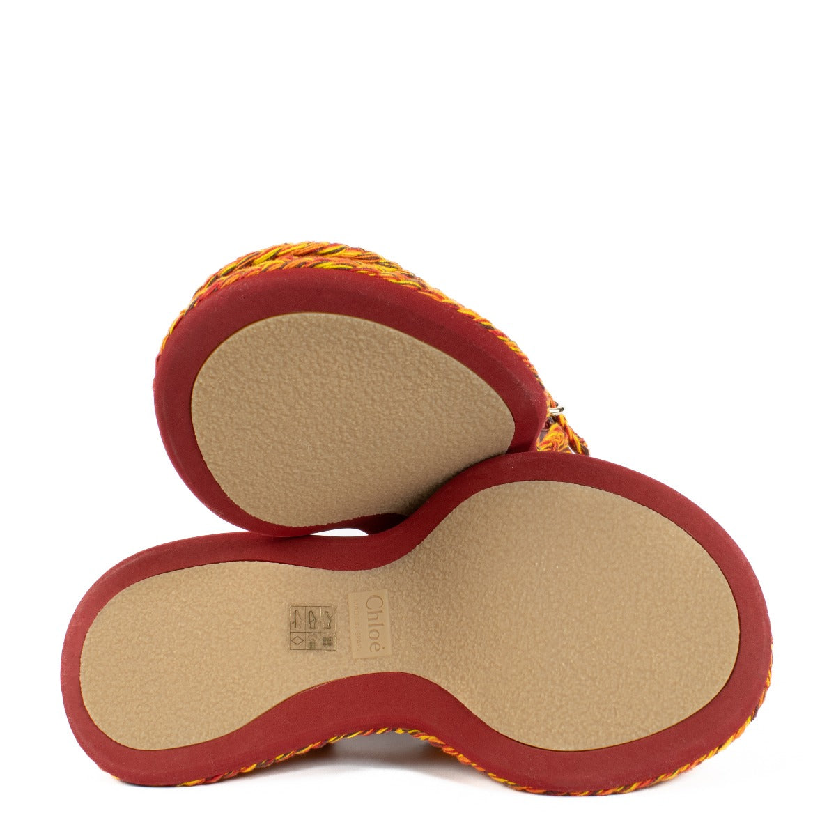 The Chloé Meril sandals in orange feature a handwoven multicolor cotton design with a wavy, chunky platform and adjustable ankle strap. Buy now on Labellov.com.