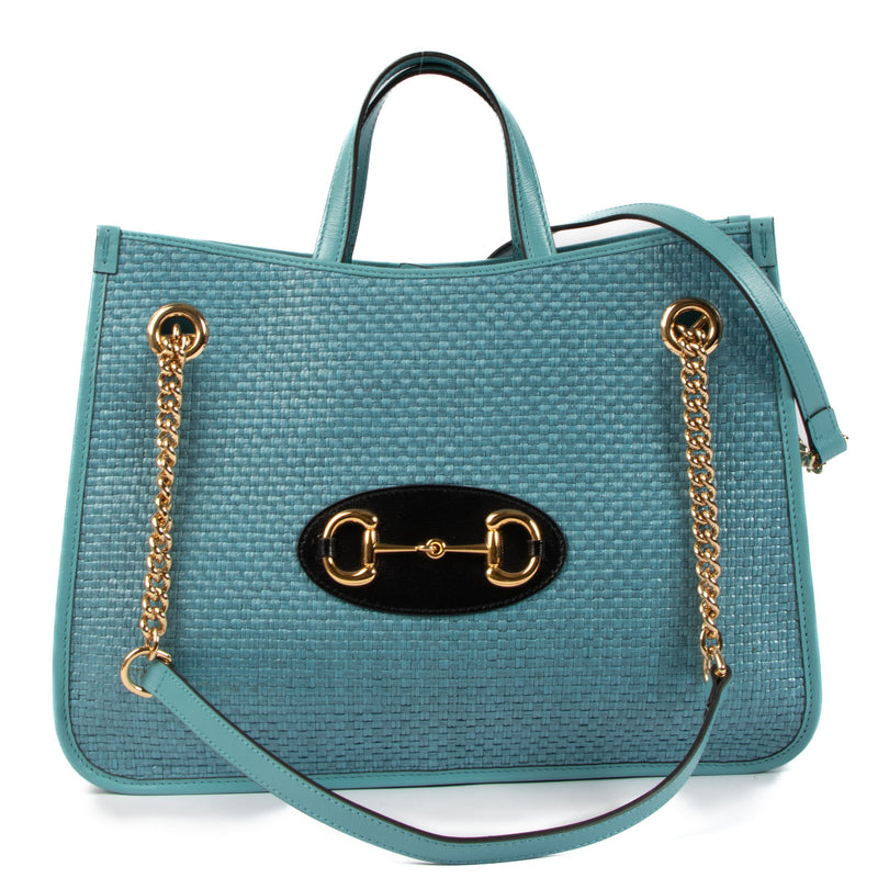 The Gucci Blue Raffia Horsebit 1955 Tote Bag is a stunning blend of heritage and modern style, showcasing the timeless appeal of the brand’s iconic designs while offering a fresh, contemporary twist. This bag is the perfect accessory for those who appreci