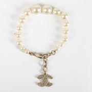 Shop the authentic Chanel Pearl Bracelet with crystal CC charm in champagne-gold hardware at Labellov.com.