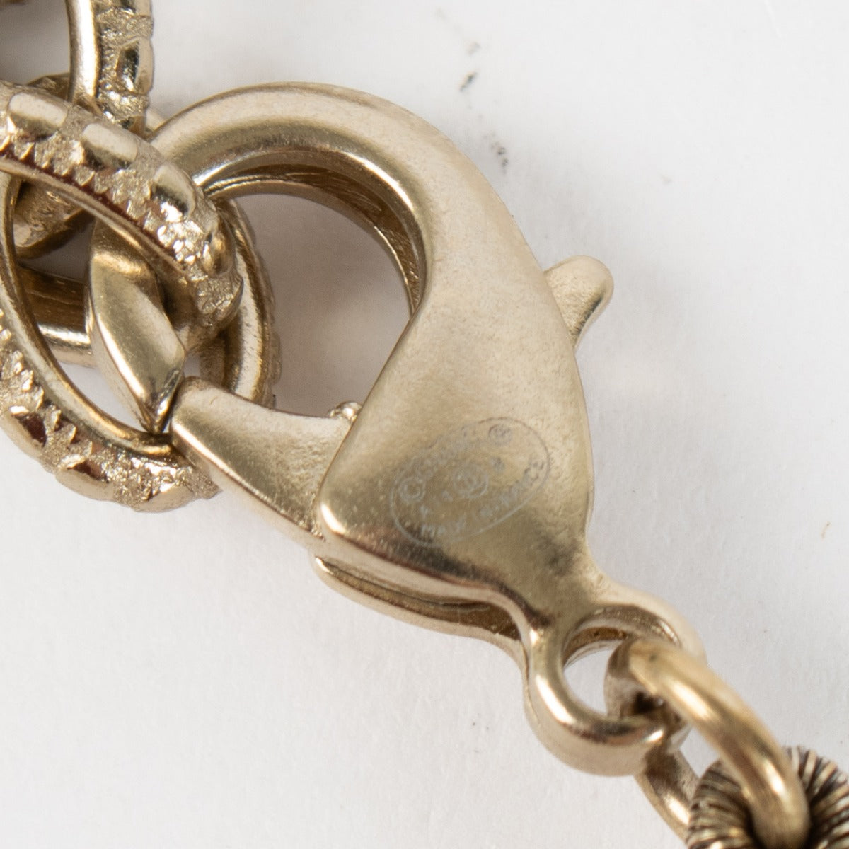 Shop the authentic Chanel Pearl Bracelet with crystal CC charm in champagne-gold hardware at Labellov.com.