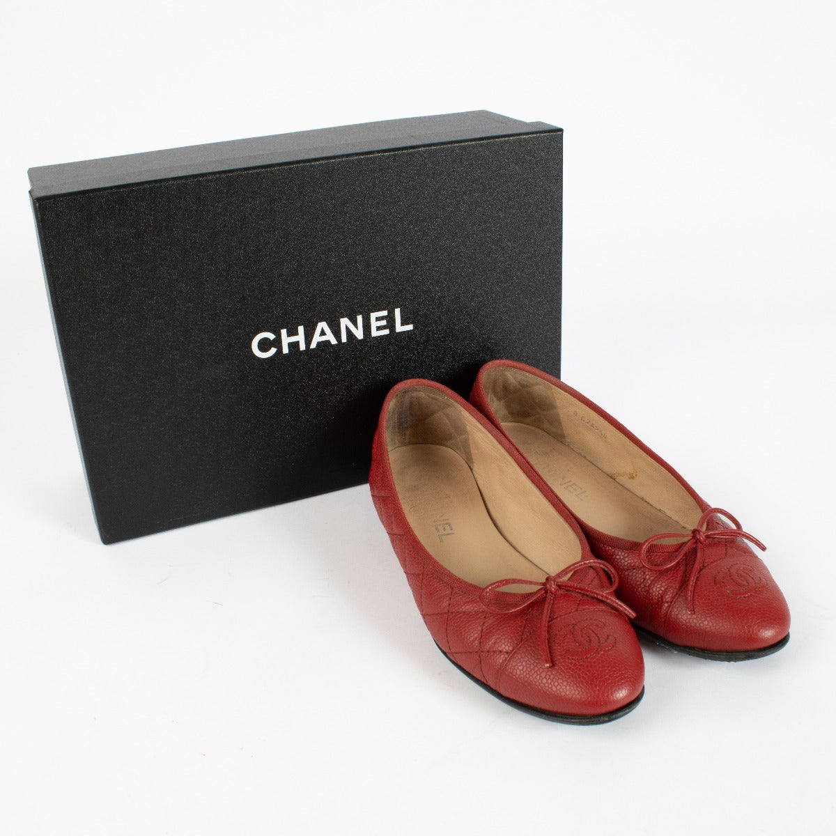 Chanel red quilted caviar leather ballerina flats with CC logo, bow detail, and original box at Labellov.com