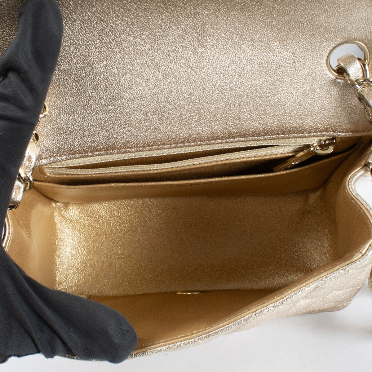 Discover the Chanel Gold Quilted lambskin Square Mini Flap Bag in metallic lambskin with gold hardware timeless, elegant, and in very good pre-loved condition, available at Labellov.com.