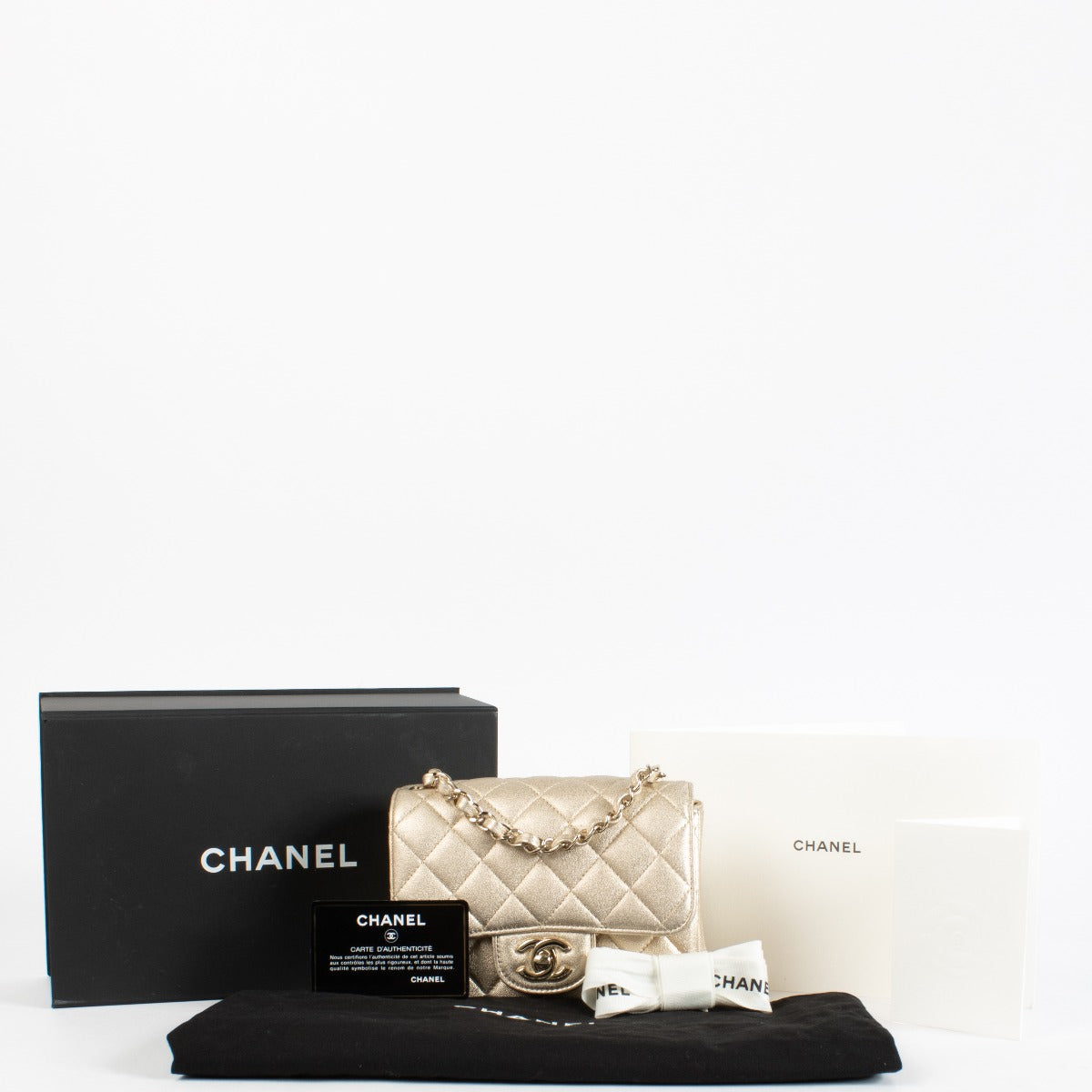 Discover the Chanel Gold Quilted lambskin Square Mini Flap Bag in metallic lambskin with gold hardware timeless, elegant, and in very good pre-loved condition, available at Labellov.com.