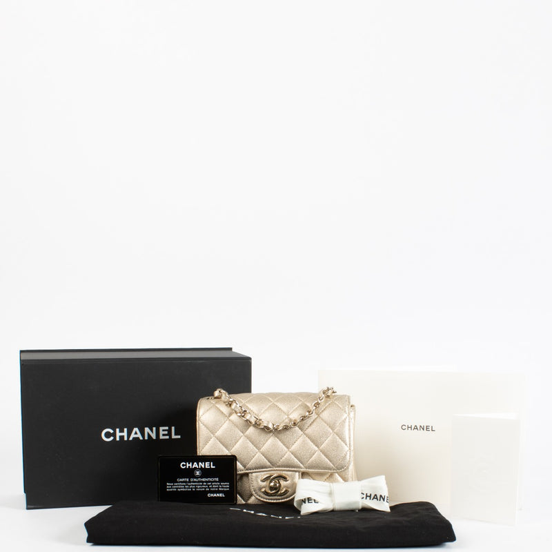 Discover the Chanel Gold Quilted lambskin Square Mini Flap Bag in metallic lambskin with gold hardware timeless, elegant, and in very good pre-loved condition, available at Labellov.com.