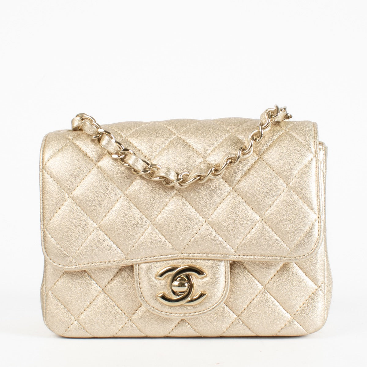 Discover the Chanel Gold Quilted lambskin Square Mini Flap Bag in metallic lambskin with gold hardware timeless, elegant, and in very good pre-loved condition, available at Labellov.com.