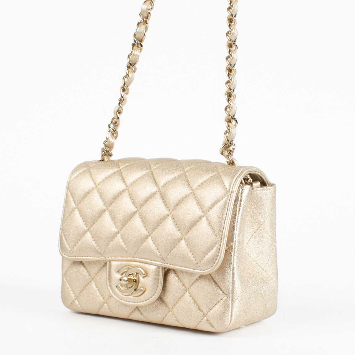 Discover the Chanel Gold Quilted lambskin Square Mini Flap Bag in metallic lambskin with gold hardware timeless, elegant, and in very good pre-loved condition, available at Labellov.com.