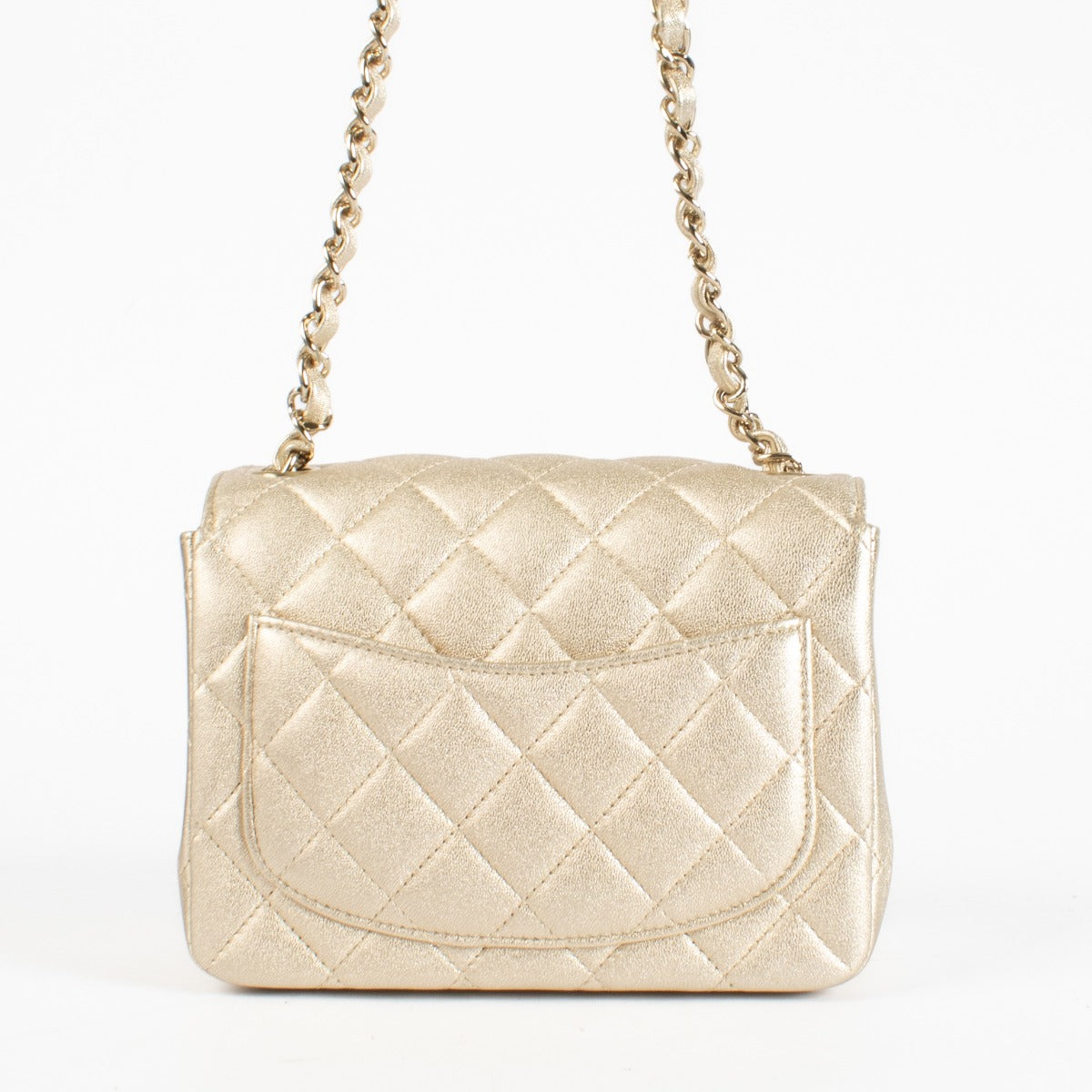 Discover the Chanel Gold Quilted lambskin Square Mini Flap Bag in metallic lambskin with gold hardware timeless, elegant, and in very good pre-loved condition, available at Labellov.com.