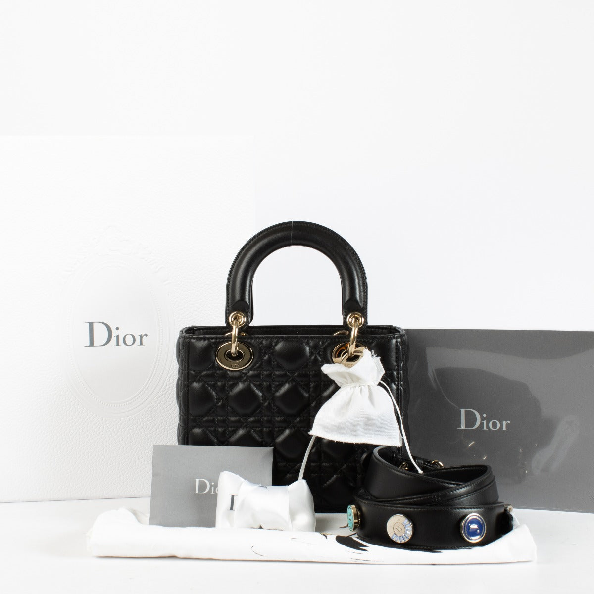 Christian Dior Small Lady Dior Bag in black lambskin with gold hardware and red interior, full set with care booklet and receipt at Labellov.com