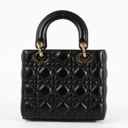 Christian Dior Small Lady Dior Bag in black lambskin with gold hardware and red interior, full set with care booklet and receipt at Labellov.com