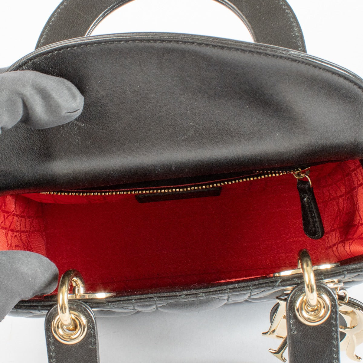 Christian Dior Small Lady Dior Bag in black lambskin with gold hardware and red interior, full set with care booklet and receipt at Labellov.com