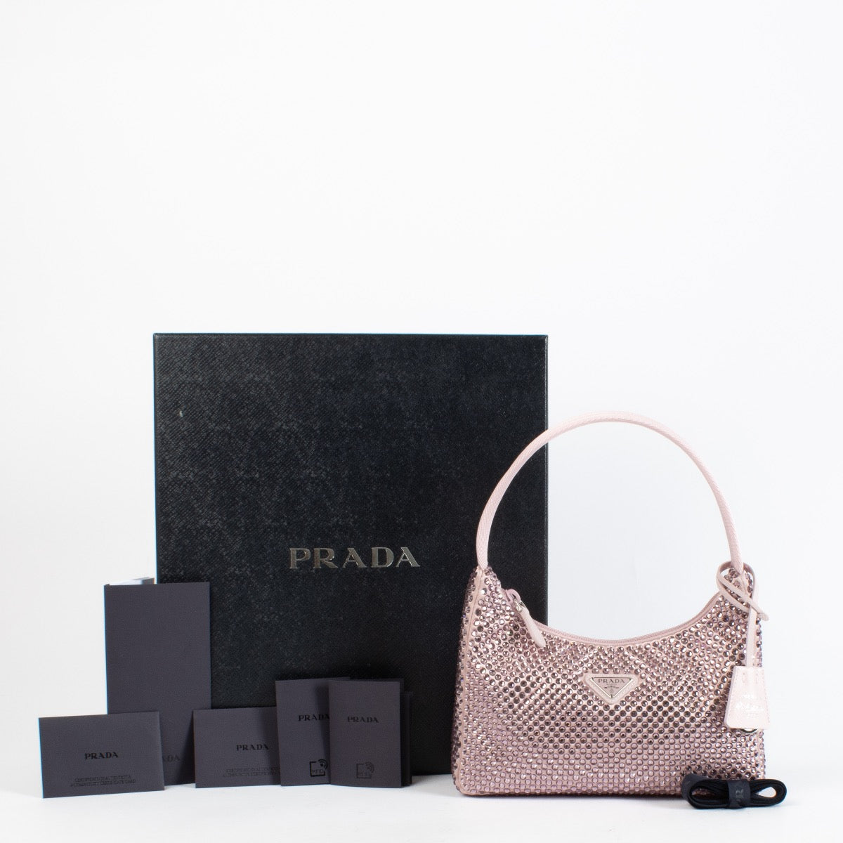 Authentic Preloved Prada Alabaster Pink Re-Edition mini satin bag with crystals on Labellov.com