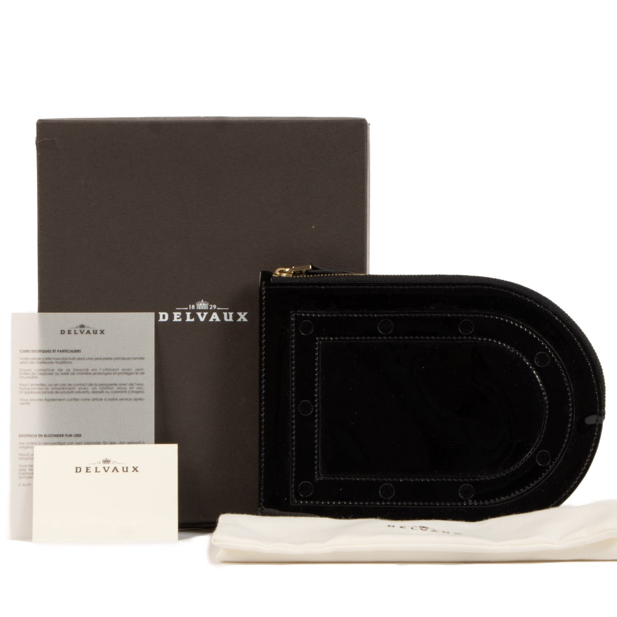 Buy an authentic Delvaux Black Patent Leather Louise Clutch on LabelLov.com