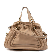 mbrace effortless sophistication with the Chloé Dusty Pink Paraty Shoulder Bag, a stunning accessory that embodies the brand's signature bohemian-chic aesthetic. Crafted from luxurious suede and smooth leather, this bag features a soft, dusty pink hue tha