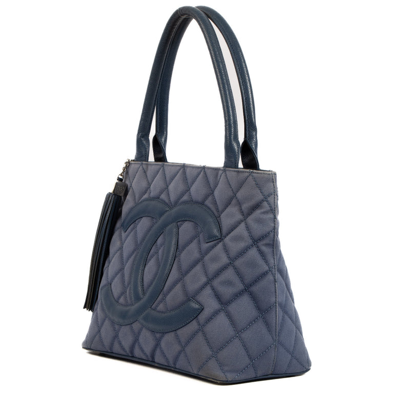 Are you looking for an authentic designer bag for the best price? Chanel Blue Quilted Canvas Medallion Tote Bag