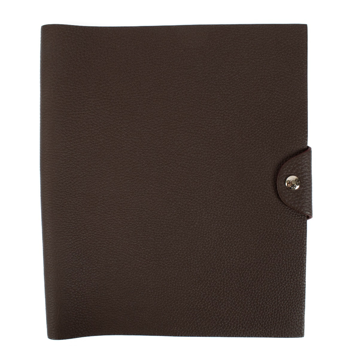 The Hermès Ulysse is a sleek leather notebook holder with a minimalist design, featuring luxurious craftsmanship and a spacious interior for essentials.
