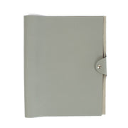 The Hermès Ulysse is a sleek leather notebook holder with a minimalist design, featuring luxurious craftsmanship and a spacious interior for essentials. Shop now a Labellov.com.