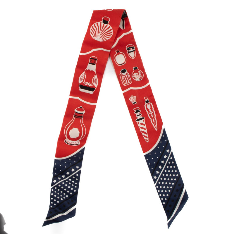 Shop safe online at Labellov in Antwerp, Brussels and Knokke this 100% authentic second hand Hermès Marine / Rouge / Blanc Silk Les Flacons Twilly Scarf