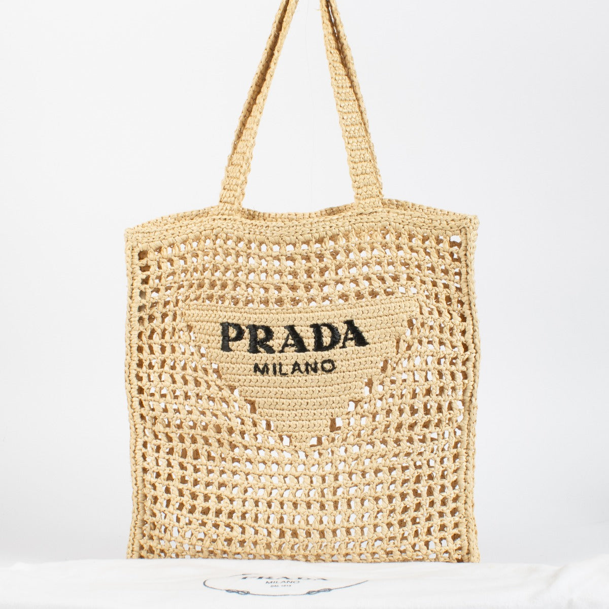 Prada Beige Raffia Tote with black embroidered logo. A lightweight, summery Prada design in excellent pre-loved condition.