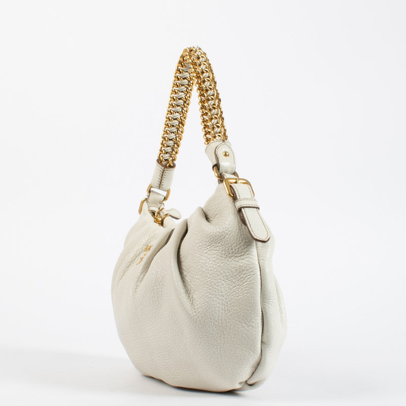 Prada White Shoulder Bag in soft leather with gold chain handle. A refined and versatile Prada design in very good pre-loved condition.