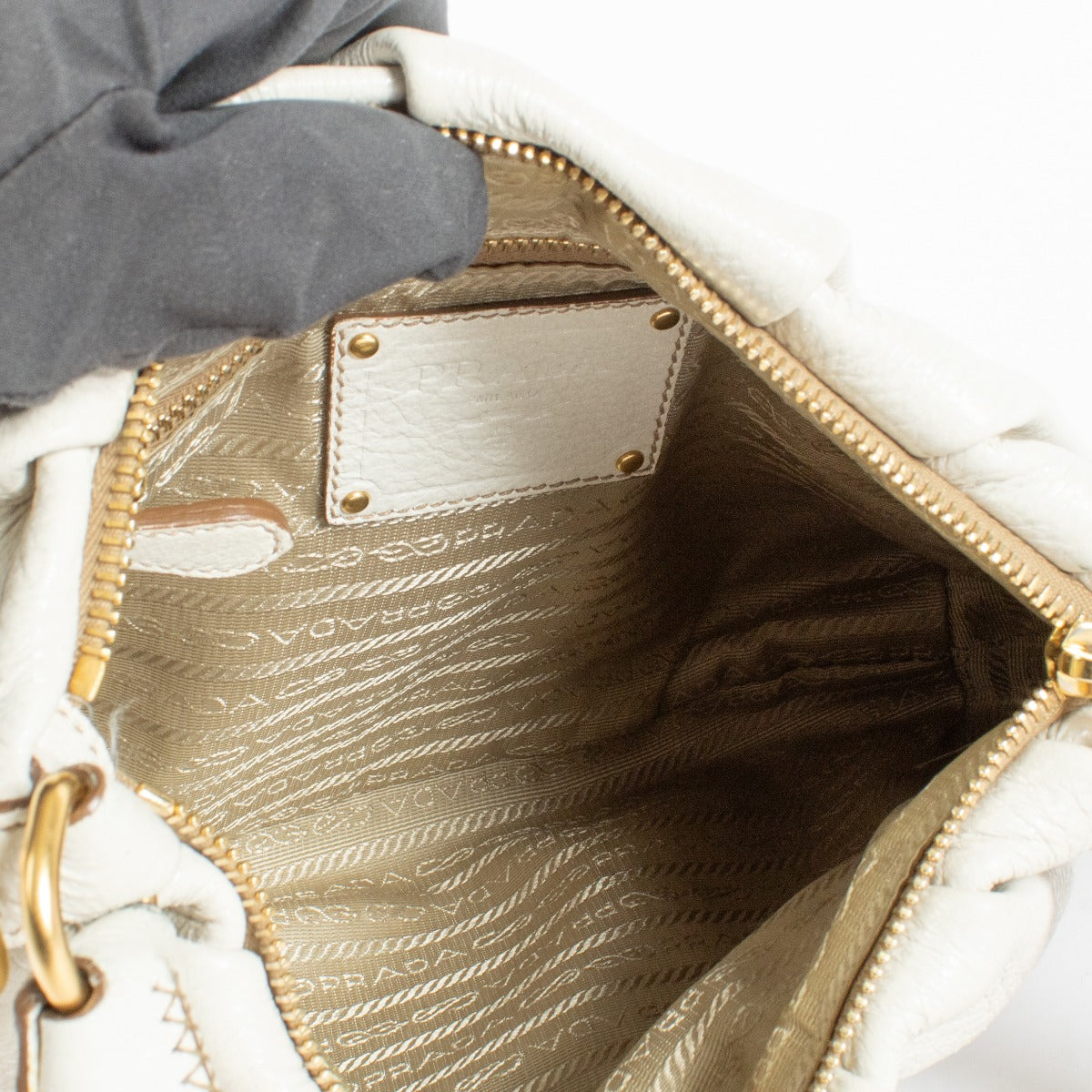Prada White Shoulder Bag in soft leather with gold chain handle. A refined and versatile Prada design in very good pre-loved condition.
