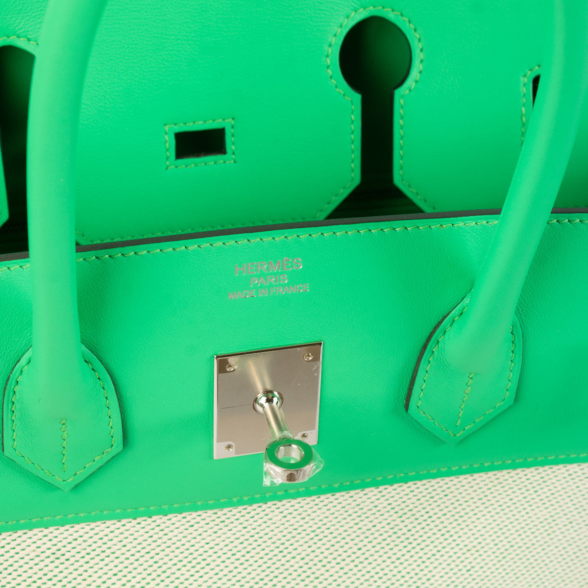 Close-up of Hermès Birkin 35 Twill Ecru Vert Comics with Palladium hardware and twill material.'