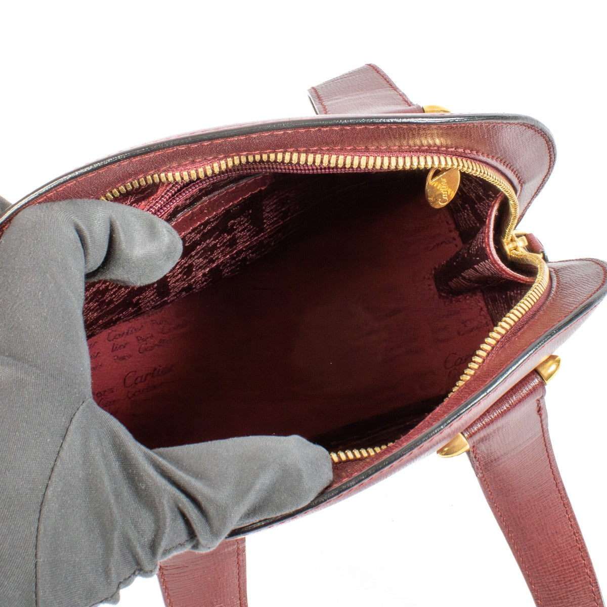 Shop safe online at Labellov in Antwerp, Brussels and Knokke this 100% authentic second hand Cartier Vintage Burgundy Mustline Rounder Tote Bag