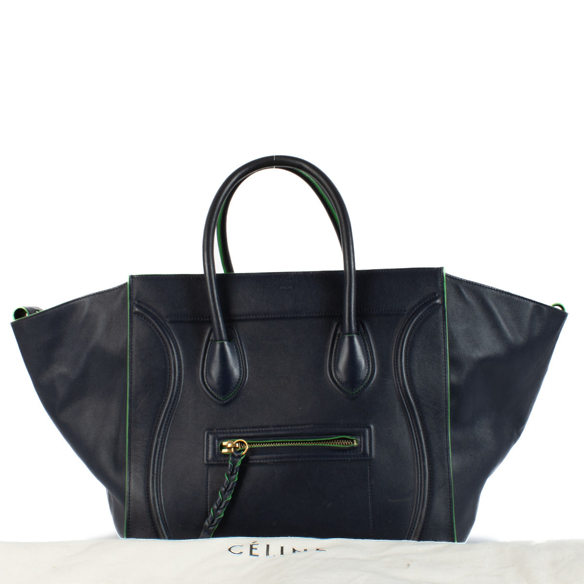 The Celine Navy Blue Medium Luggage Phantom Top Handle Bag is a striking combination of bold design and refined craftsmanship. Made from premium calfskin leather, this iconic bag stands out with its sculptural silhouette, curved lines, and winged sides, e