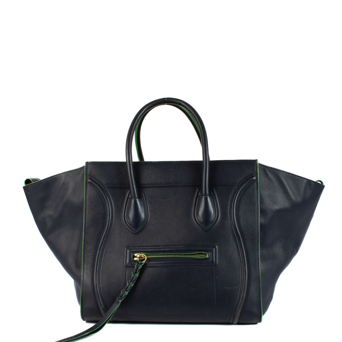 The Celine Navy Blue Medium Luggage Phantom Top Handle Bag is a striking combination of bold design and refined craftsmanship. Made from premium calfskin leather, this iconic bag stands out with its sculptural silhouette, curved lines, and winged sides, e