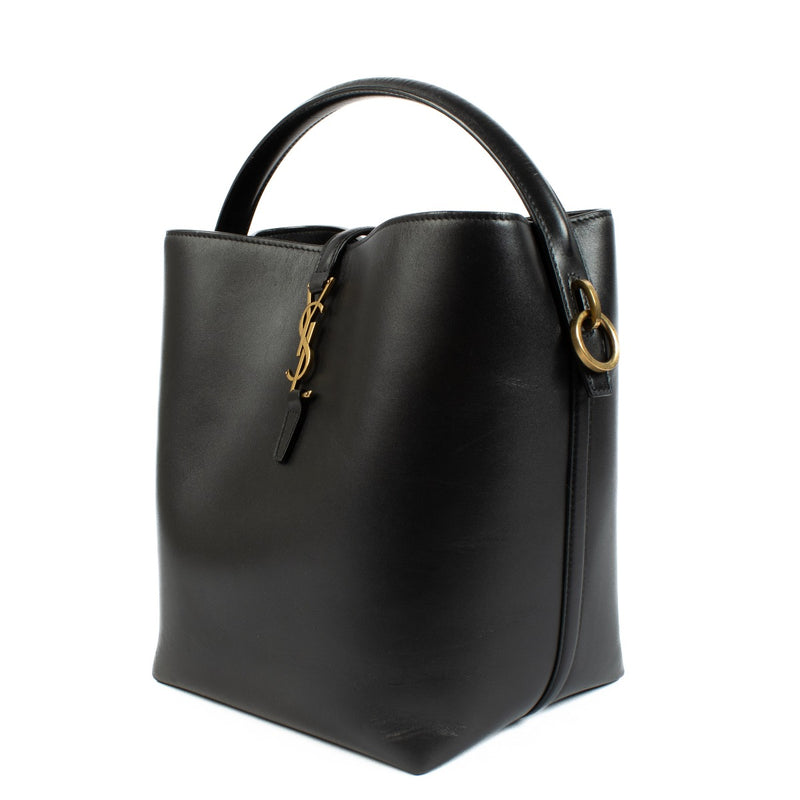 Elegant calfskin bucket bag with Cassandre closure, suede lining, and bronze-toned hardware. Shop at Labellov.
