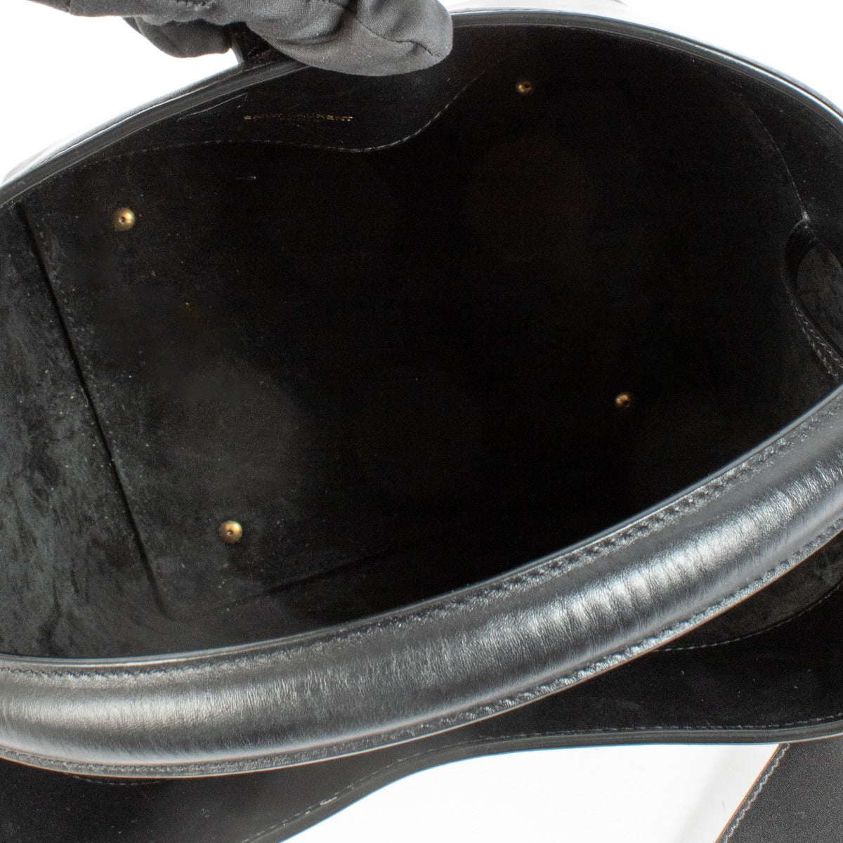 Elegant calfskin bucket bag with Cassandre closure, suede lining, and bronze-toned hardware. Shop at Labellov.